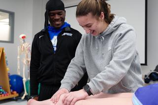 Physical Therapy students working together on patient