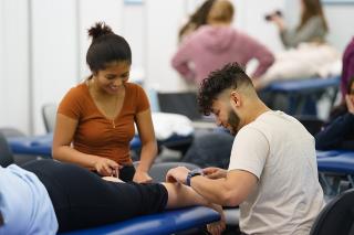 Physical Therapy students working together on patient