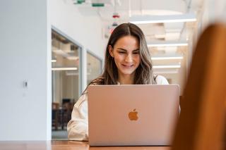 Student working in library on macbook