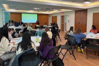 Tables full of Simmons students participating in a STEM Career Choices workshop