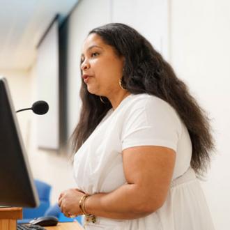 Arielle Gray at the podium during the 2026 Ifill Forum