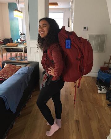 Kelsey wearing a very large backpack in preparation for her trip to Bali.