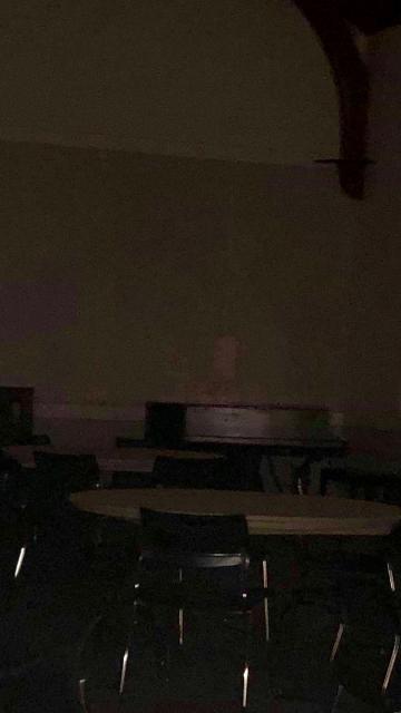 A possible apparition sitting at a table in the Linda K. Paresky Conference Center.