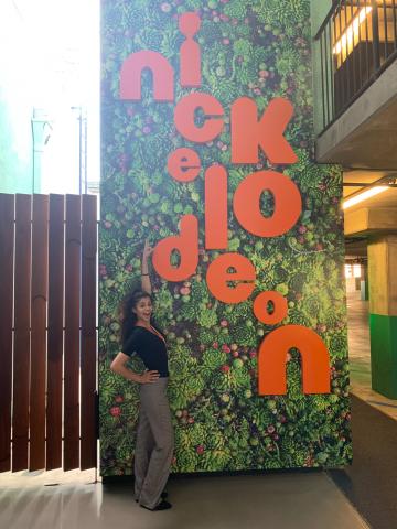 Yasmine Ebeed stand next to nickelodeon sign