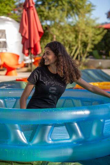 Yasmine Ebeed sitting in pool waiting to be slimed. 