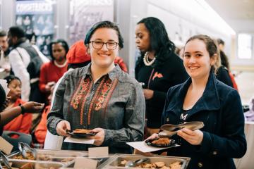 Attendees getting food before the start of the Ifill Stamp event.