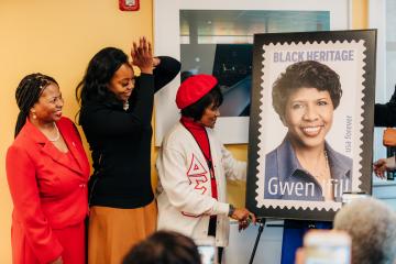 Ifill's friends cheering as the stamp is unveiled.