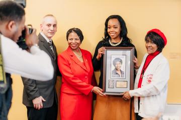 Ifill's friends and postal representative with the stamp