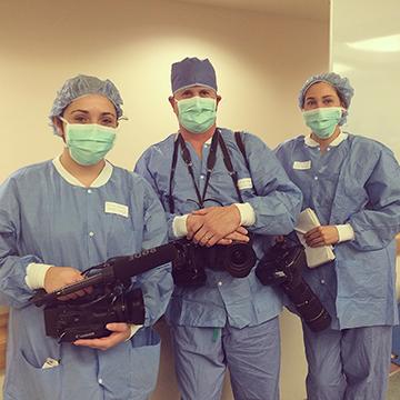 Erica Moura (on left) covering an emmy-nominated story on robots in the operation room.