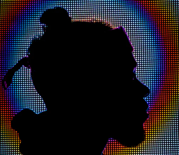 Silhouette of person in front of digital screen