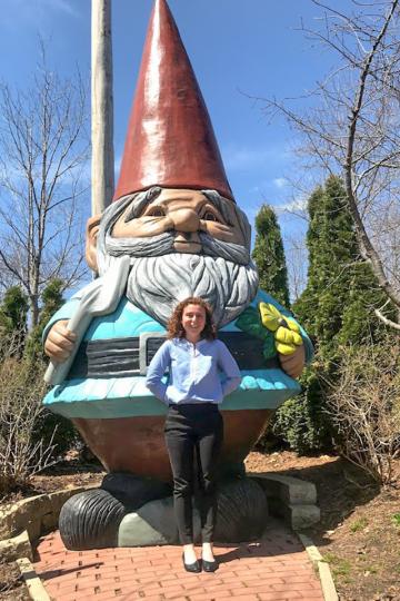 Bethanie standing in front of the world's largest concrete gnome.