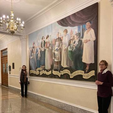 State House Curator Susan Greendyke Lachevre (left) and Michelle Jenney (right) attend the installation on December 15, 2022