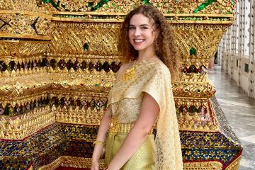 Lauren Murphy wearing traditional chut thai clothing at Wat Arun temple