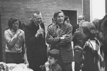 Faculty and staff enjoying a reception during the opening of the Park Science Center. Foreground: (l to r) Peter Bowers (?), Quentin Peterson, Carroll Miles (Prof. of Government), Peterson's wife. Child is John Bell, Jerry Bell's younger son. Background: Jerry Bell (w glasses), Walter Steere (Business Manager).