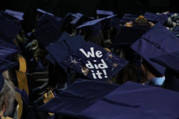 A Commencement cap with the message "We did it!"