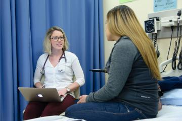 A Simmons nursing student conducting a patient interview