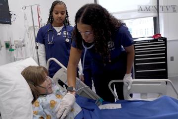 Nursing students working with the young simulation patient in the Simmons simulation center