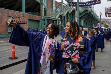 Many students lined up near Fenway Park to process into Commencement