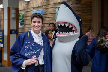 A graduating student poses with Stormy