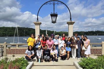 A group of Simmons students taking part in a summer research experience at the Muddy River