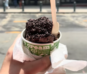 A student holding a cup of ice cream from Ben and Jerry's in Boston
