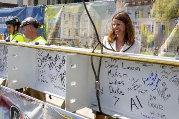 Kerri Brophy, VP of Enrollment, signing the beam at the LLC Topping Off Ceremony