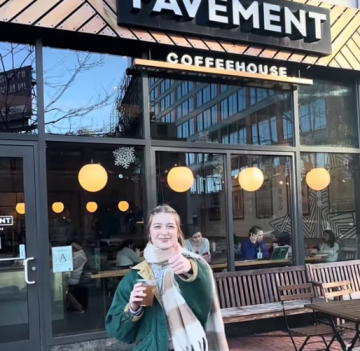 A student giving the thumbs up outside Pavement Coffee in Boston