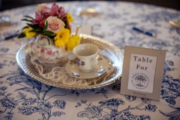 A small tea set being used as a table centerpiece at the Women's College Coalition event in 2026