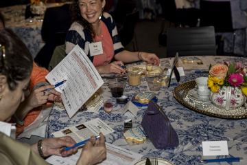 Attendees working on a group project at the Women's College Coalition event in 2026