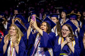 Graduating students applaude and cheer during the 2026 Commencement ceremony. Photo credit: Natalya Lavrenov