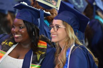 Graduating Simmons students are all smiles during the 2026 Commencement ceremony. Photo credit: Ivana Lucero, Grad Images.