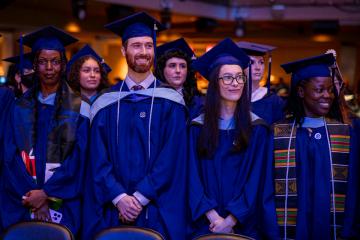 A group of graduate students standing during Commencement 2026
