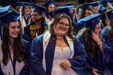 An undergraduate student smiling brightly on Commencement day 2026. Photo credit: Natalya Lavrenov.