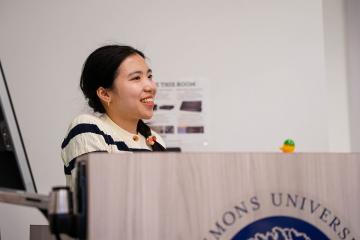 An undergraduate student at the podium during the 2026 STEM Colloquium