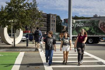 Three Simmons students walking in a crosswalk in Boston