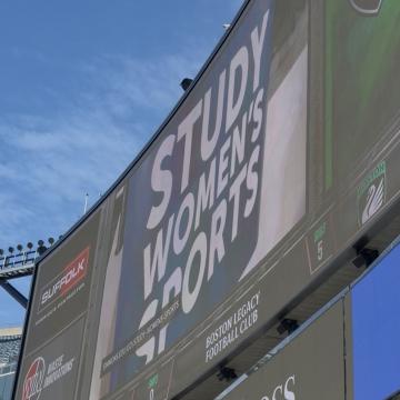 Study Women's Sports being displayed on the jumbotron during a Legacy game