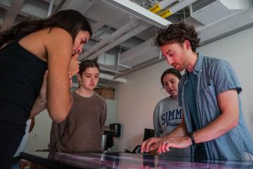 Assistant Professor Steve Wechsler working with students on an anatomage table