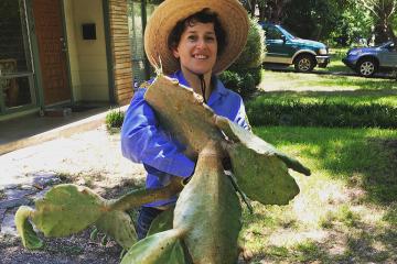 Cindy Fisher holding a giant cactus.