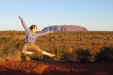 Christina Zaharevich posing in front of Uluru in Australia.