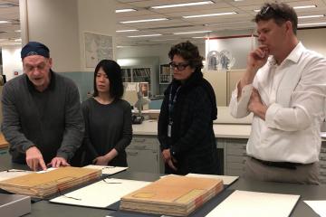 Conservators Alan Haley, Qui Qi, Ann Roddy, and Dan Patterson in the conservation department of the Library of Congress, working with the Yongle Da Dian.