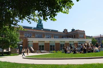 Students sitting together on the academic campus quad.