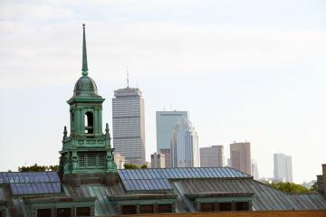 Simmons University Main College Building's cupola with the Boston city skyline in the background