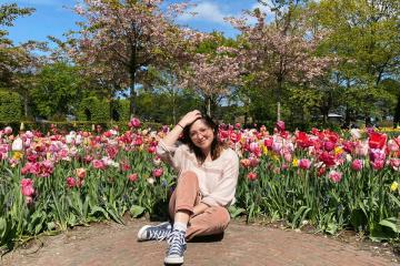 Lauren Wagner in sitting in front of flowers