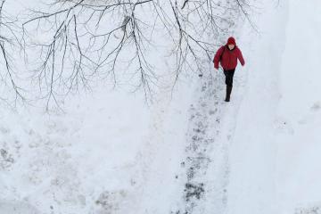 Simmons Student walking on a snowy path