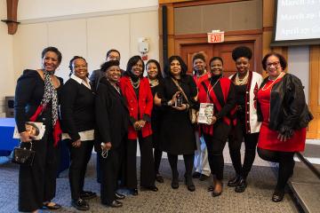 April Ryan holding 2023 Gwen Ifill Next Generation Award posing with President Wooten and group of women