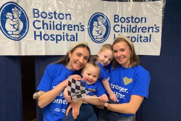 Olivia Panagiotou ’23 and Kaitie Panagiotou ’18 holding two small children