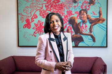 Simmons University President Lynn Perry Wooten wearing a pink jacket and smiling