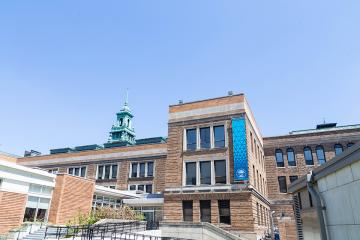 Main Campus Building under a bright blue sky