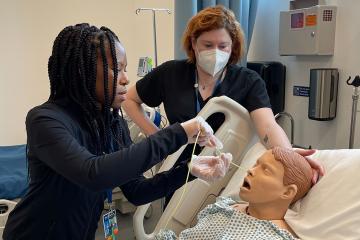 Students working on test patient mannequin