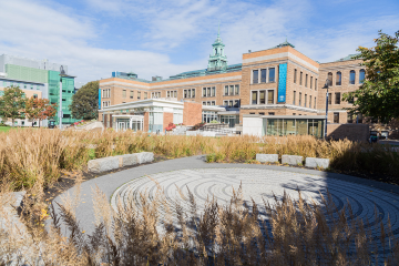 The Simmons University campus with the brick labyrinth in the foreground and the main campus building in the background